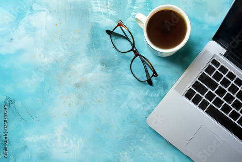 Modern Office Desk Setup with Laptop, Coffee Cup, and Eyeglasses for Productive Work Environment