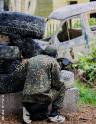 Wallpaper Mural Paintball game, team in camouflage protective uniform with paintball guns and ammunition, strikeball arena battlefield, paintballer aiming and shooting at opponents, airsoft players match tournament Torontodigital.ca