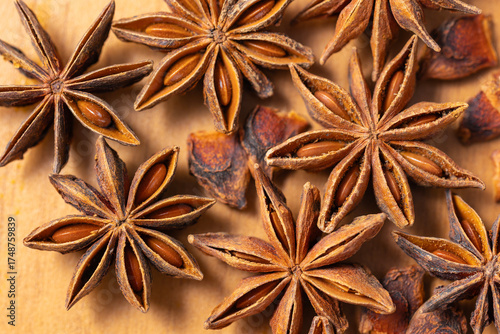 Aromatic anise stars on a wooden background.