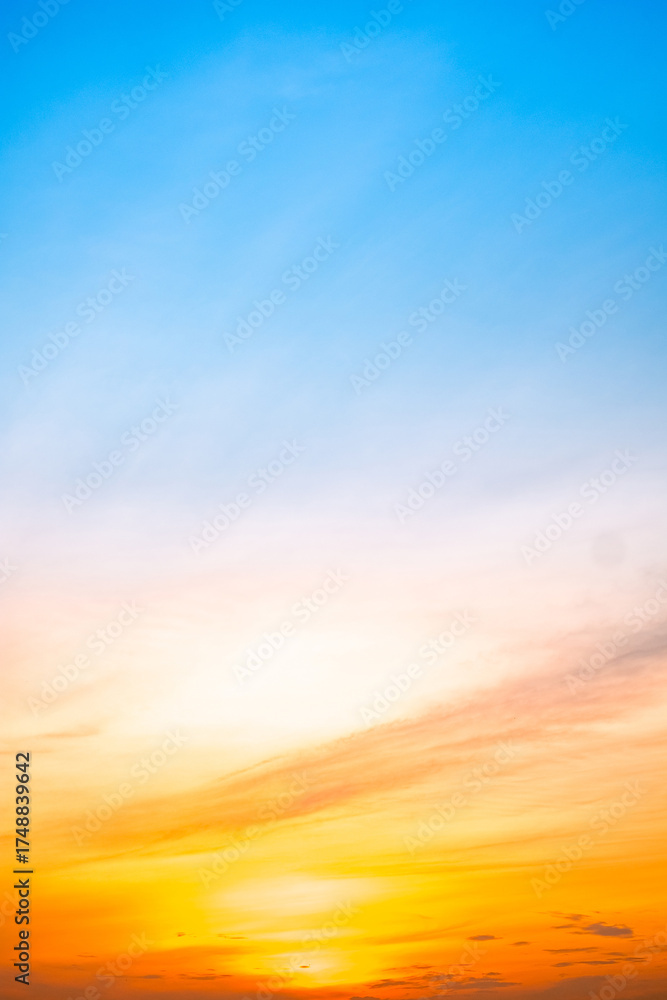 Fototapeta premium Beautiful , luxury soft gradient orange gold clouds and sunlight on the blue sky perfect for the background, take in evening,Twilight, Large size, high definition landscape photo,Vertical