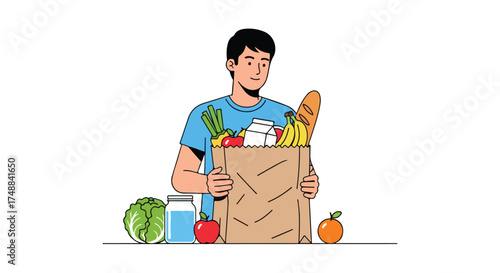 Young man holding grocery bag full of varied fresh foods with additional produce on the side isolated on a white background