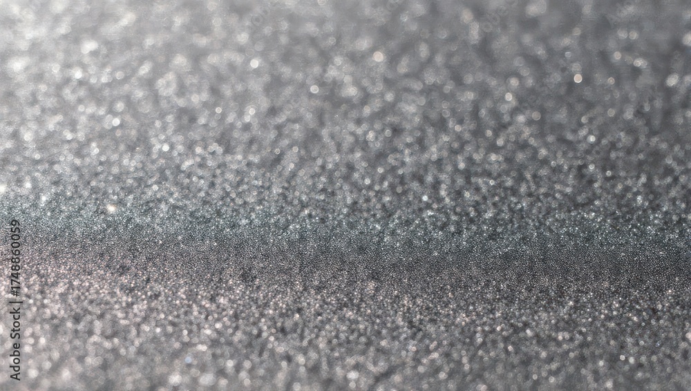 Obraz premium Abstract sparkling silver glitter texture background. Close-up of shimmering grey granular surface with light reflections.