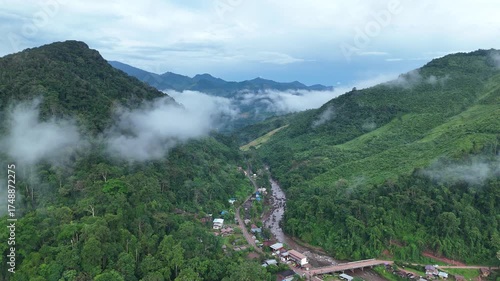 Aerial view of the village located on a plateau mountain with verdant rice fields surrounding Nan Province in the north of Thailand. Sapan village. 	
