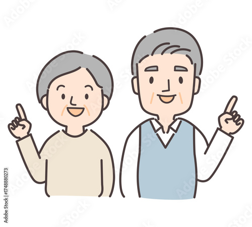 笑顔で指差しをするシニア夫婦