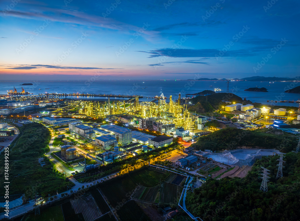 Fototapeta premium Petrochemical plant and oil refinery operating at night on the coast. Industry and energy background.