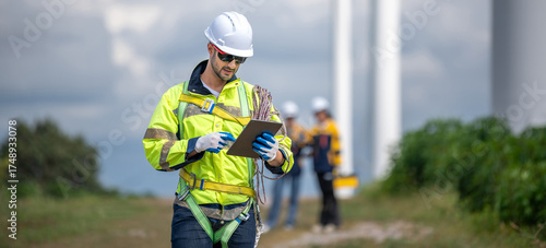 Male man engineer inspection by tablet gesture check control wind power machine out door wind energy factory. technician professional worker check wind power machine turbine field inspection