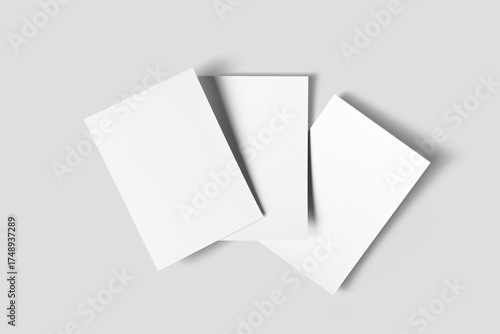 Three Blank A4 Paper Sheets Arranged on a Neutral Grey Background