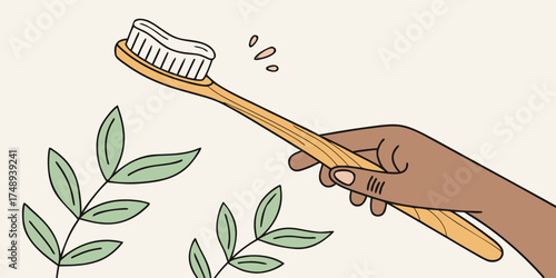Hand holding wooden toothbrush with toothpaste on bristles  
