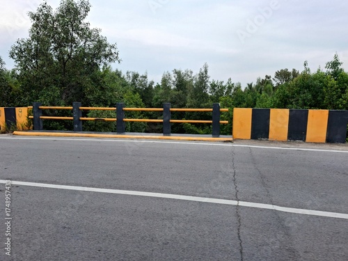 Bridge fence, with yellow and black colors