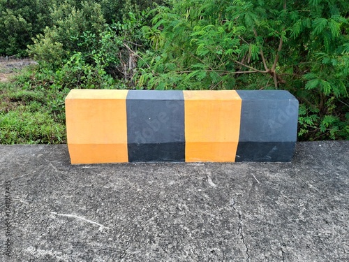 Concrete Road Barrier on the side, With Yellow and Black Colors