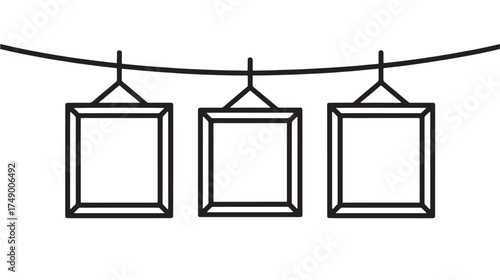 Three empty square frames hanging on a wire, ready for memories or art.