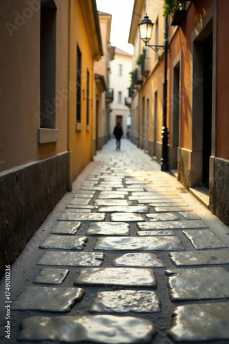 Sunlit Cobblestone Alleyway A Solitary Figure Walks Towards the Light in a Picturesque European Street