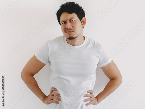 Asian man posing confidently edgy with hands on waist in white t-shirt in white shirt and clean background