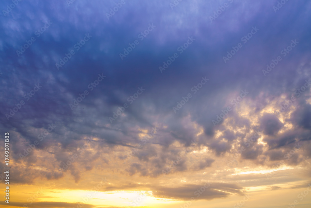 Fototapeta premium Beautiful colorful evening or morning fluffy clouds in sky. Blue and yellow cloudscape at sunset or sunrise. Nature background.