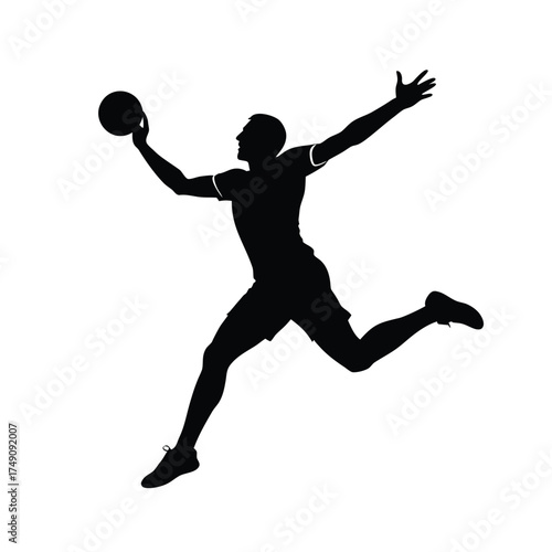 Silhouette of a male athlete jumping with a ball sport