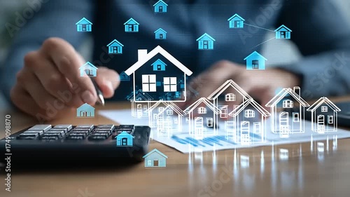 Person calculating real estate values with digital house icons and graphs on the table in office