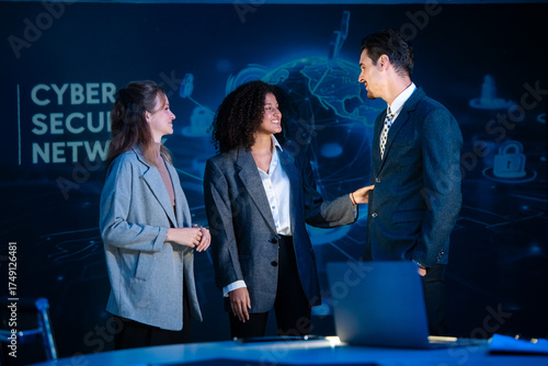 Colleagues brainstorming and sharing ideas in a modern tech office with a cybersecurity background.