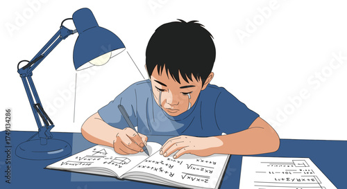A young boy concentrating intently while doing homework under a desk lamp.