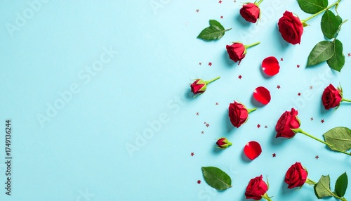 Elegant Red Roses, Petals, and Stars on a Sky Blue Background - Romantic Floral Composition with Copy Space