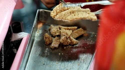 Close up cutting deep fried boneless chicken using scissors