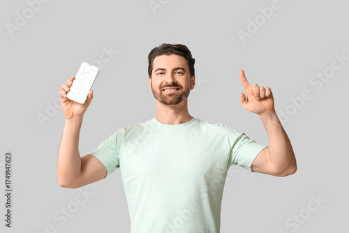 Young man with modern mobil...
