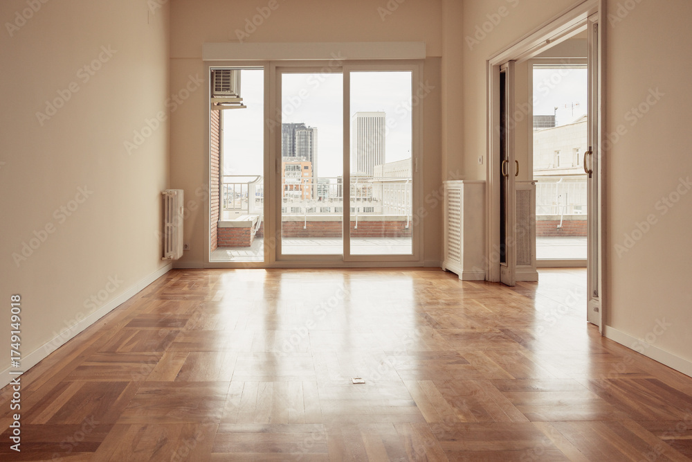 Fototapeta premium Empty apartment room with city skyline view