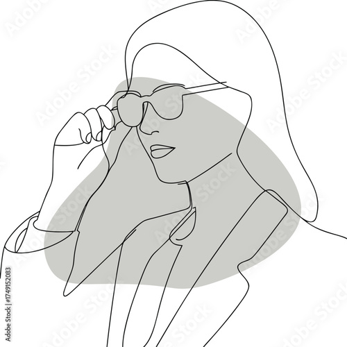 Woman wearing sunglasses adjusting them hand face