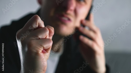 A man is talking on the phone in an emotional tone and shouting loudly.
Conflictual dialogue over the phone.
A man is arguing with someone over the phone and shouting.