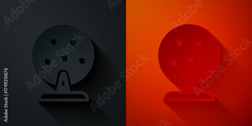 Paper cut Lottery machine with lottery balls inside icon isolated on black and red background. Lotto bingo game of luck concept. Wheel drum leisure. Paper art style. Vector
