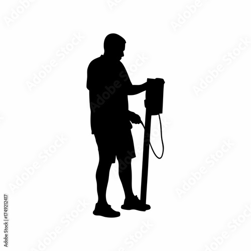 Silhouette of a rehabilitation worker setting up electrotherapy machine isolated on white background