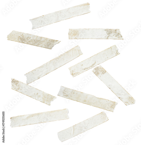 collection of long, diagonally oriented, scattered strips of vintage, stained beige masking tape, featuring rough edges, isolated on a transparent background.