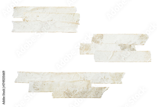 photograph of two clusters of layered and overlapping pieces of distressed, grungy beige masking tape isolated on a clean transparent background.