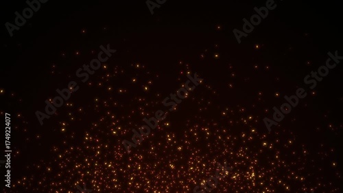 Flying sparks and coals from a fire. Abstract glowing particles of burning fire on a black background. Animated coal particles. Fire Sparks on black background. Fire embers glow.  4K, seamless loop.