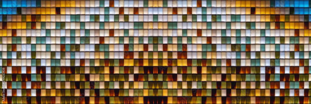 Fototapeta premium Colorful transparent glass bricks forming a decorative wall