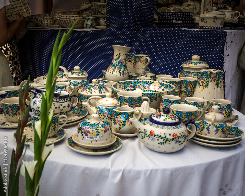 Fototapeta premium Traditional handmade pottery at the ceramics festival in old town market square in Boleslawiec, Poland.