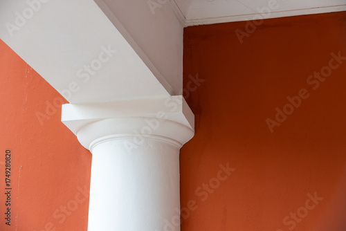 Wallpaper Mural A pristine white column and decorative capital stand beside a bold red wall Torontodigital.ca