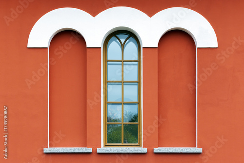 Wallpaper Mural Red building facade features a white rounded arches and a tall window and niches Torontodigital.ca