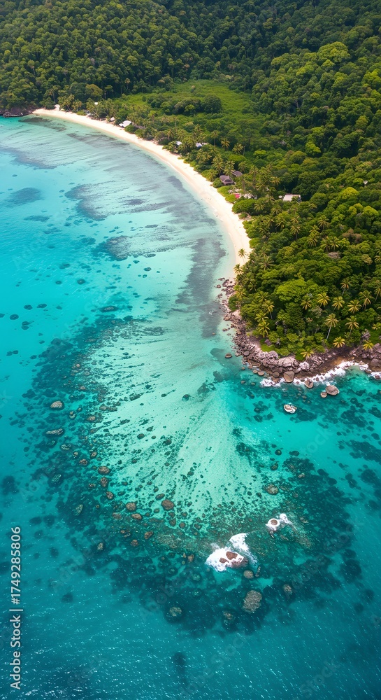 Fototapeta premium Aerial view of a pristine tropical island coastline with lush green jungle meeting turquoise clear ocean waters and vibrant coral reefs below