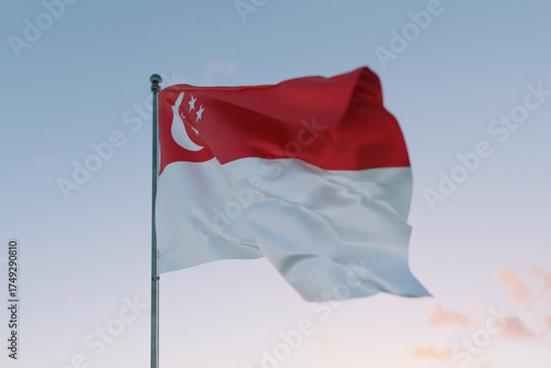 National flag of Singapore waving in the wind against a clear sky, symbolizing patriotism, independence, national pride, and unity.