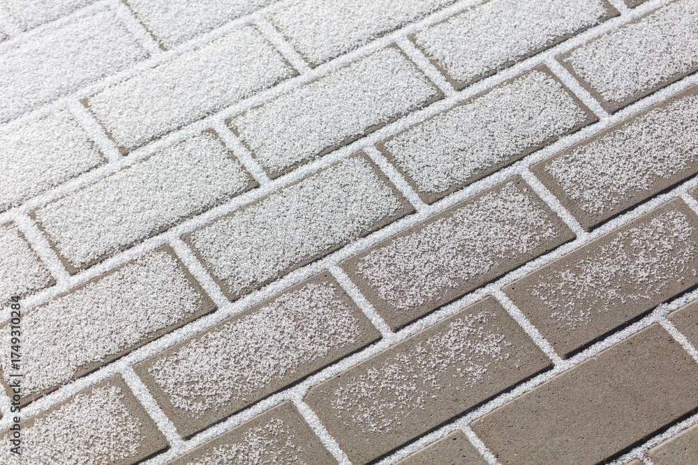 Fototapeta premium A brick wall covered in snow