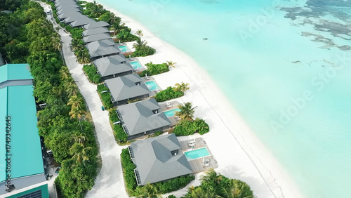 Εκτύπωση καμβά An aerial view of a row of luxury beachfront villas, each with a private pool, l