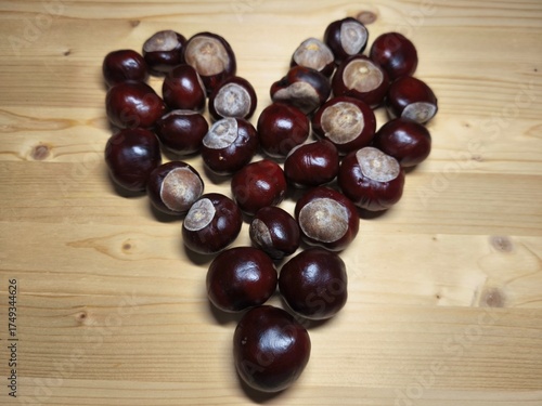Chestnuts Arranged in Heart Shape on Wooden Table