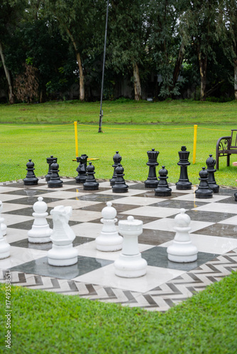 a giant outdoor chess board on a well maintained lawn