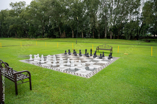 a giant outdoor chess board on a well maintained lawn