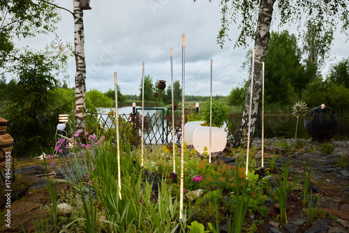 A Beautiful and Tranquil Garden Featuring Vibrant Flora by the Waters Edge Beneath Overcast Skies