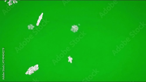 Light snowflakes drifting gently downward, isolated on a green screen background.