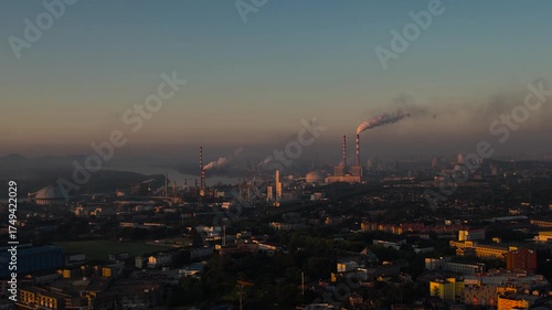Industrial City Sunrise Aerial View with Factory Smokestacks Emitting Pollution and Chemical Exhaust