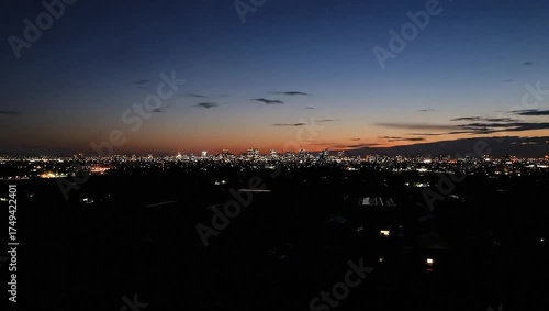 Wallpaper Mural Aerial shot of a city skyline during sunset, featuring fields in the foreground and clouds above Torontodigital.ca