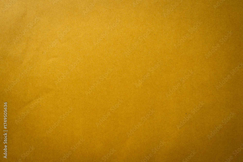 Fototapeta premium Brown paper texture background with soft lighting, ideal for minimal design, presentation template, poster layout, website background, or business stationery concept.