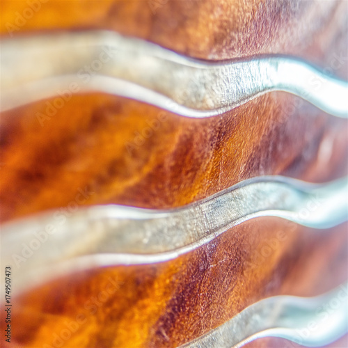 Abstract fluid texture with swirling orange and white waves. Macro photograph of paint mixing creating marbled effect with vibrant colors and copy space.